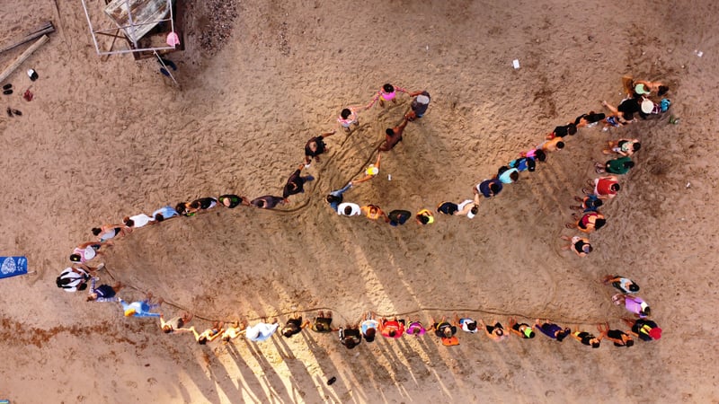 Whale shape created by group of people